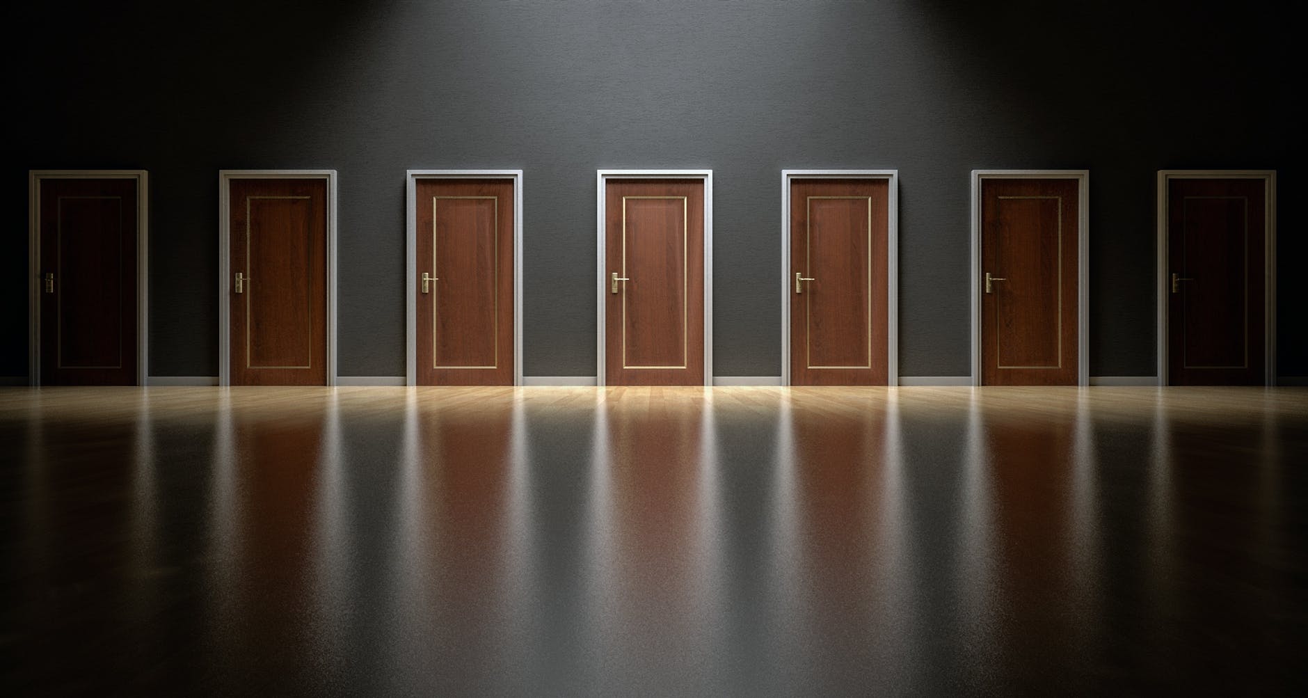 A row of six wooden doors on a dark wall, with polished wooden flooring reflecting the light.