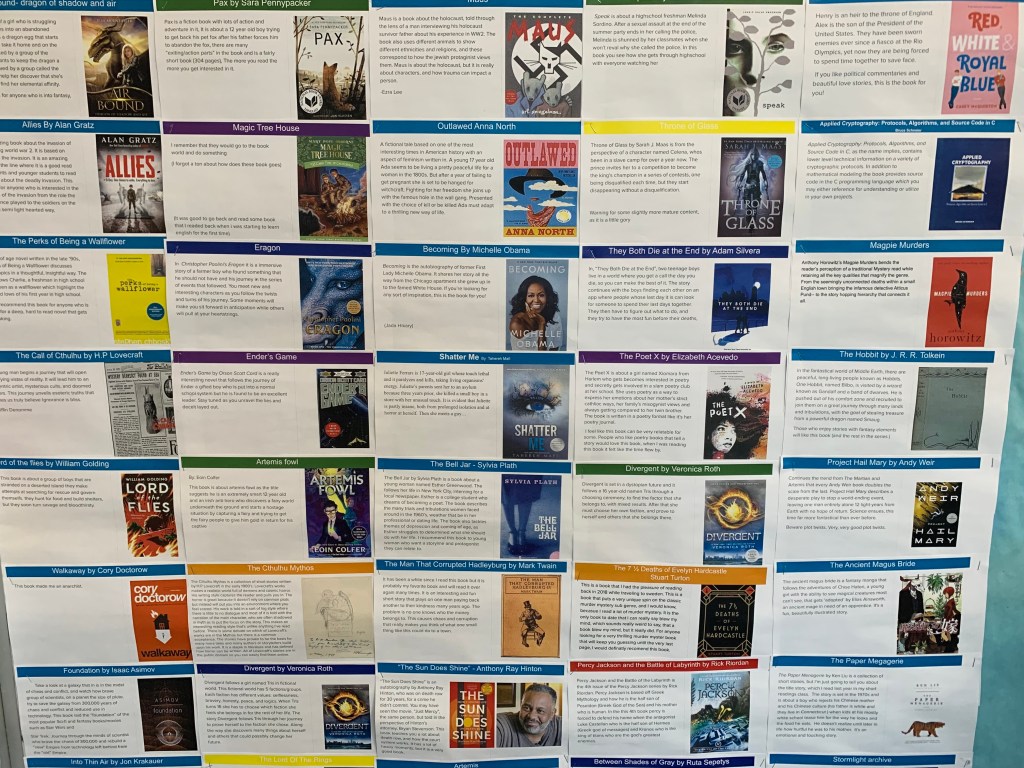 A colorful bulletin board displaying book recommendations with covers and brief descriptions of various books.
